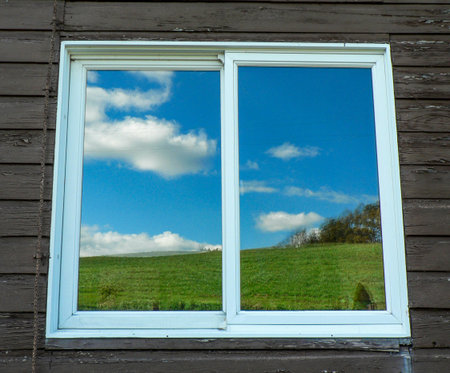 Green Hill and Blue Skies Reflected on a Window, Ohio