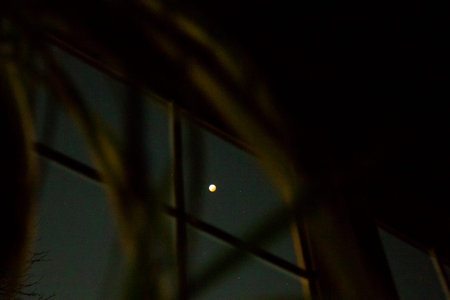 Looking at a Total Lunar Eclipse Through a Windowの写真素材
