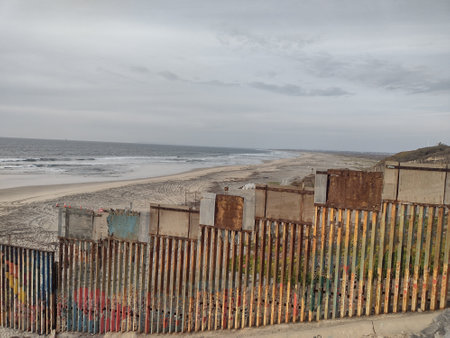 Gloomy View of Rusty Protective Border Wall Mexico Tijuana and United Statesの写真素材