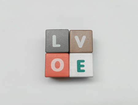 a series of letters in a children's toy puzzle block into the word loveの写真素材