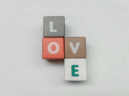a series of letters in a children's toy puzzle block into the word loveの写真素材
