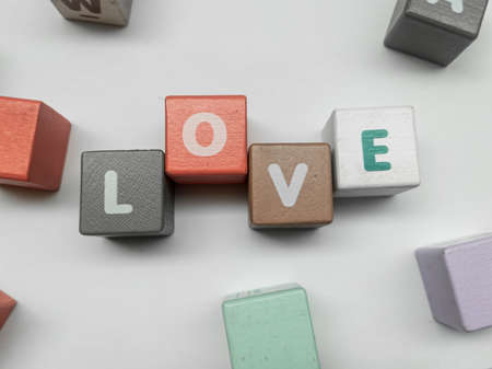 a series of letters in a children's toy puzzle block into the word loveの写真素材