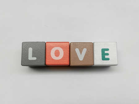 a series of letters in a children's toy puzzle block into the word loveの写真素材