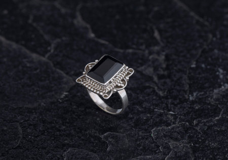 Sterling Silver Ring on Black Stone Backgroundの写真素材