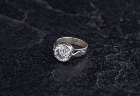 Sterling Silver Ring on Black Stone Background