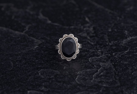 Sterling Silver Ring on Black Stone Backgroundの写真素材