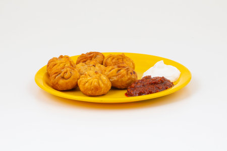 Fried Momos is a Traditional Dumpling Food From Nepal Served with Schezwan Sauce & Creamの写真素材