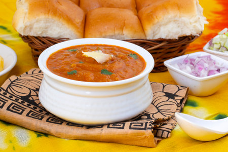 Pav Bhaji is a Indian Traditional Popular Street Fast Food. Thick And Spicy Vegetable Curry Served With a Soft Bread Roll/Bun Paav And Butterの写真素材