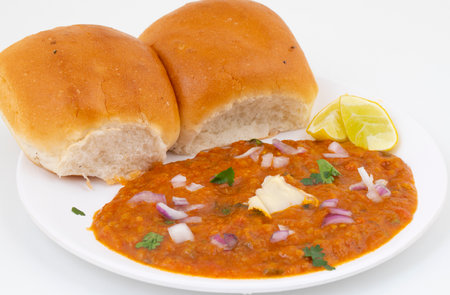 Pav Bhaji is a Indian Traditional Popular Street Fast Food. Thick And Spicy Vegetable Curry Served With a Soft Bread Roll/Bun Paav And Butterの写真素材