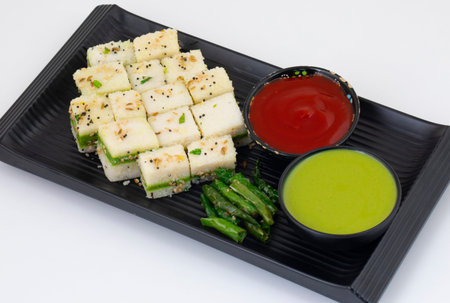 Sandwich Dhokla or Sandwich Khaman is an Indian Popular Snack Made of Chick Pea Flour or Rice Flour,...