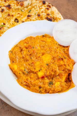 Indian Vegetarian Cuisine Special Sweet And Spicy Paneer Pasanda or Stuffed Paneer Curry, Delicacy Consisting of Stuffed Paneer with Rich Creamy Gravy Served With Garlic Naanの写真素材
