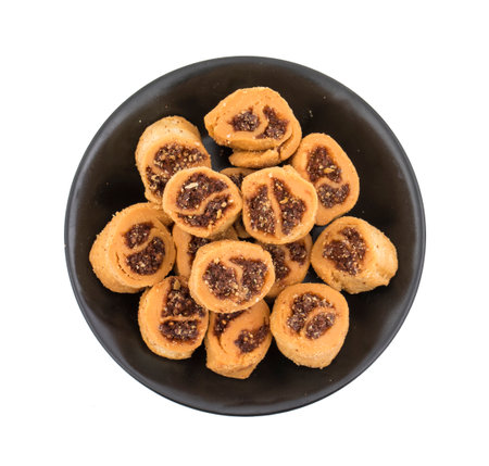 Indian Fried Bhakarwadi Tea Time Snack also known as bakarwadi, bakarvadi, bakar vadi, bakar wadi or spring roll is a traditional spicy Maharashtra and Gujarat Snack isolated on White Backgroundの写真素材