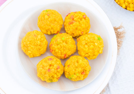 Laddu also know as laddoo, ladoo, laddo are ball-shaped sweets popular in the Indian festivals. Laddu are made of flour, minced dough and sugar with other ingredientsの写真素材