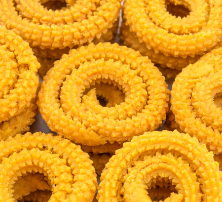 Indian Traditional Deep Fried Snack Chakli Also Called Chakali, Chakri, Murukku, Muruku, Murkoo Group of Backgroundの写真素材