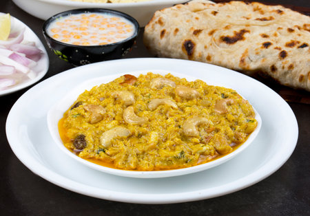 Indian Traditional Vegetarian Cuisine Kaju Curry Also Called Kaju Butter Masala Served with Tandoori Roti, Raita, Salad And Papadの写真素材