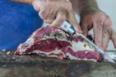 cut the meat on a table of wood