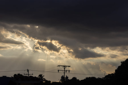 Sunset in the city with rays of light shining through the clouds