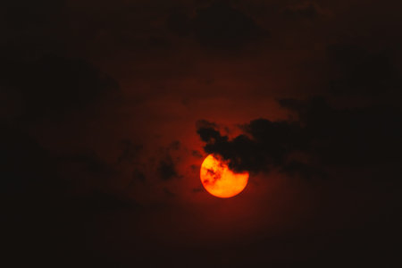 Red full moon in the sky with clouds at sunset. Natural background.