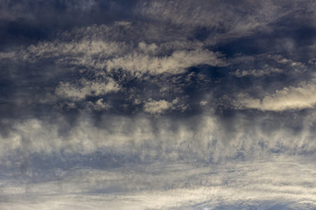 Clouds in the blue sky as an abstract background. Texture.