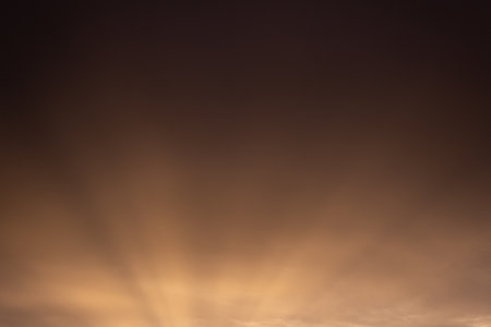 Sunset sky with clouds and sunbeams. Natural background.の写真素材