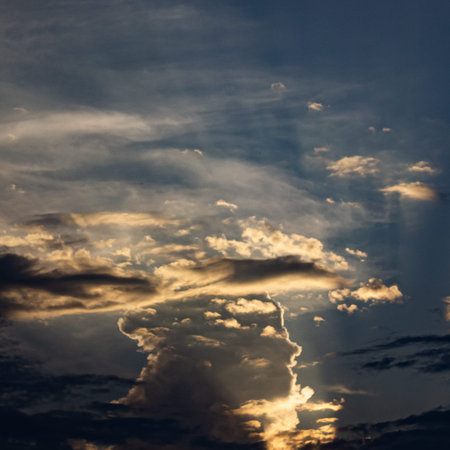 Dramatic sky with clouds and sunbeams at sunset.