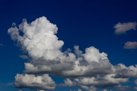 Blue sky background with white clouds. White fluffy clouds in the blue sky.