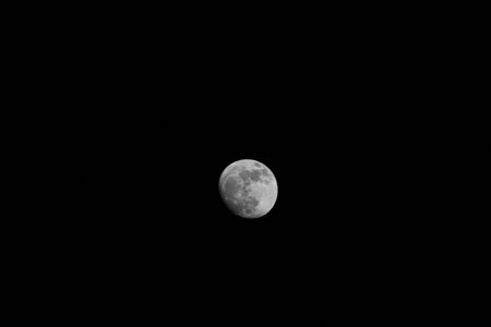 Full moon in the night sky, black and white color tone.