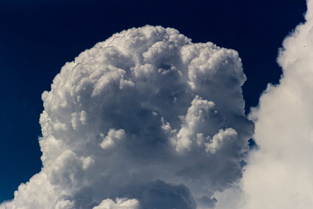 The vast blue sky and clouds create a stunning sky background.