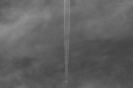 Airplane flying in the cloudy sky.