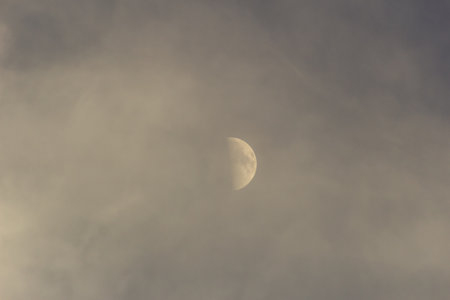 Moon in the clouds on a cloudy day. Selective focus. Toned.の写真素材