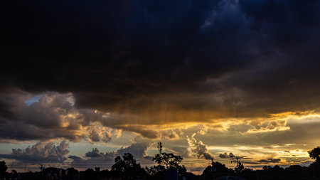Dramatic sunset sky with dark clouds and rain clouds over the city