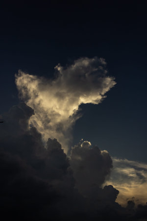 Cloudscape, Colored Clouds at Sunset near the Ocean with a Dark Sky
