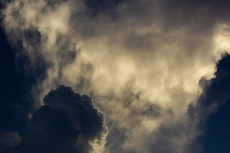 Stormy clouds in the dark blue sky. Abstract nature background.