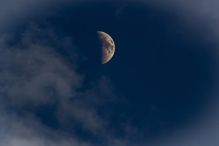 The moon in the dark blue sky with clouds, natural background.の写真素材