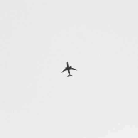 Plane flying in the sky. Black and white photos. Copyspace.の写真素材