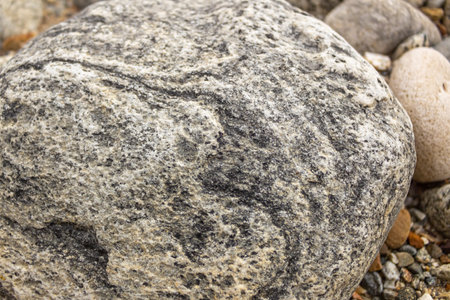 Close up of a large stone on the beach. Texture, backgroundの写真素材