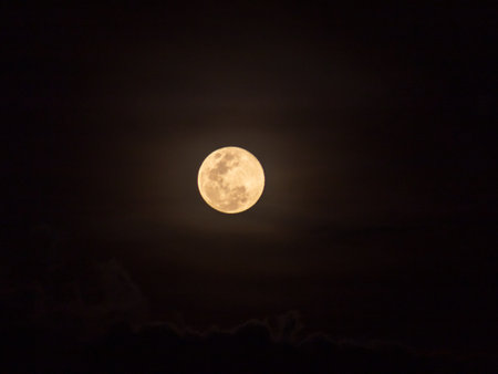 Full moon in the night sky with clouds, closeup of photoの写真素材
