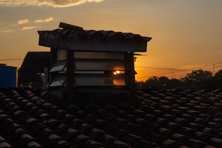 Silhouette of the roof of the house with the sunset.の写真素材
