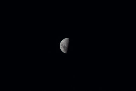 The moon in the night sky in the summer month of August.の写真素材