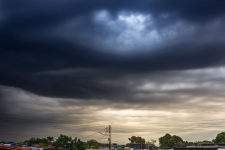 Dark stormy sky with rain clouds over the city, Thailand.
