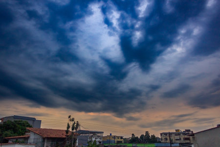 Clouds over the city in the evening, view from below.の写真素材