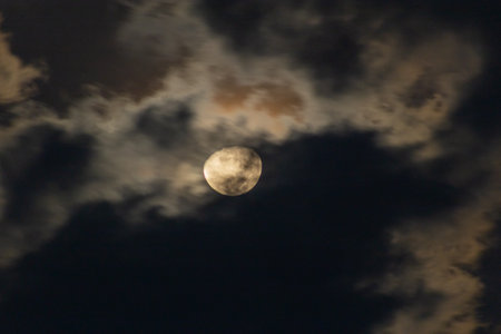 Full moon in the night sky with clouds, closeup of photoの写真素材