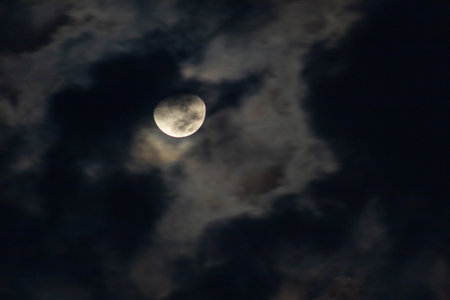 The moon in the night sky with clouds, closeup of photoの写真素材