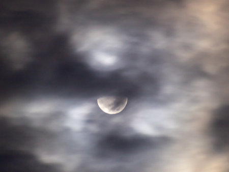 Moon in the night sky with clouds. Long exposure photo of the moon.の写真素材