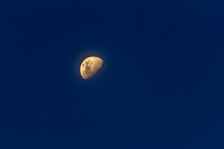 Full moon in the blue night sky with clouds, closeup of photoの写真素材
