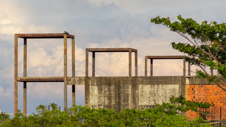 Ruins of an old factory building with cloudy sky in the background