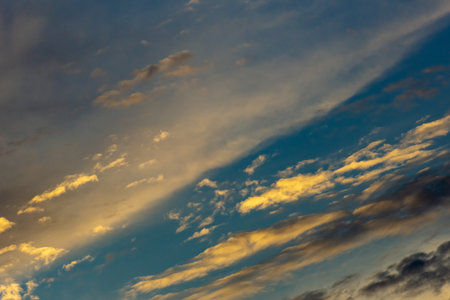 Blue sky with clouds at sunset. Nature background and texture for design.の写真素材