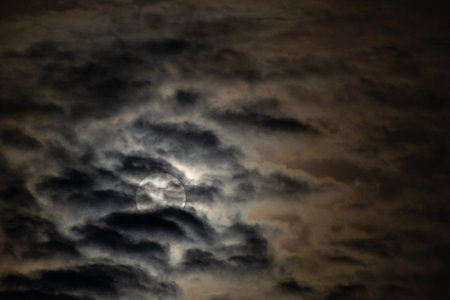 full moon and clouds in the night sky, beautiful photo digital pictureの写真素材
