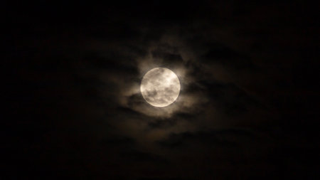 Full moon in the night sky with dark clouds, can be used as backgroundの写真素材