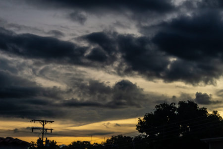 Dramatic sky with dark clouds at sunset, natural background.